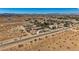 Aerial view showcasing the property's layout, desert landscape, and mountain backdrop at 4075 W Torino Ave, Las Vegas, NV 89139