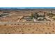 Wide aerial perspective of a desert property featuring a home and mature trees at 4075 W Torino Ave, Las Vegas, NV 89139