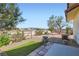 Well-maintained backyard with desert landscape, artificial turf, and mature trees at 4075 W Torino Ave, Las Vegas, NV 89139