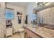 Cozy bathroom with clear vessel sink, granite countertop, and decorative shower curtain at 4075 W Torino Ave, Las Vegas, NV 89139