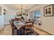 Inviting dining room featuring a large window and chandelier lighting to create a delightful eating experience at 4075 W Torino Ave, Las Vegas, NV 89139