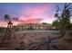Charming desert home featuring a windmill and xeriscaping in the front yard at 4075 W Torino Ave, Las Vegas, NV 89139