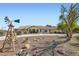 Charming single-story home with desert landscaping and a decorative windmill on a spacious lot at 4075 W Torino Ave, Las Vegas, NV 89139