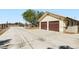 Detached two-car garage with extended driveway on a well-maintained property at 4075 W Torino Ave, Las Vegas, NV 89139