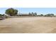Large horse riding arena on a vast property with a partial view of the home in the background at 4075 W Torino Ave, Las Vegas, NV 89139