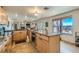Bright and open kitchen with a center island, granite countertops, stainless steel appliances and tile floors at 4075 W Torino Ave, Las Vegas, NV 89139