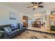 Cozy living room with a decorative rug and ample seating that connects to a dining area with natural light at 4075 W Torino Ave, Las Vegas, NV 89139