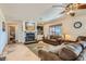 Cozy living room with a stone fireplace, TV, and comfortable seating for ultimate relaxation at 4075 W Torino Ave, Las Vegas, NV 89139