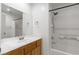 Well-lit bathroom with a wood vanity, a shower-tub combo, and a large mirror at 4076 Rocky Beach Dr, Las Vegas, NV 89115