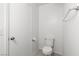 Clean, all-white powder room showcasing a toilet, towel bar, and minimalist design at 4076 Rocky Beach Dr, Las Vegas, NV 89115