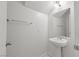 Bright bathroom featuring a pedestal sink, modern fixtures, and neutral decor at 4076 Rocky Beach Dr, Las Vegas, NV 89115