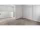 A well-lit bedroom features carpeted floors, a closet, and a door to another room at 4076 Rocky Beach Dr, Las Vegas, NV 89115