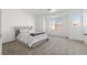 Modern bedroom with a comfortable bed, bright windows and views of the neighborhood at 4076 Rocky Beach Dr, Las Vegas, NV 89115