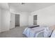 A neutral primary bedroom boasts carpeted floors and access to an ensuite bathroom and walk-in closet at 4076 Rocky Beach Dr, Las Vegas, NV 89115