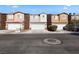 Attractive townhomes with attached garages and colorful facades, creating a welcoming community atmosphere at 4076 Rocky Beach Dr, Las Vegas, NV 89115