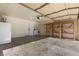 Spacious two-car garage featuring laundry hookups, storage shelving, and an insulated garage door at 4076 Rocky Beach Dr, Las Vegas, NV 89115