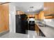 Efficient kitchen layout with black appliances and ample cabinet space, ideal for cooking enthusiasts at 4076 Rocky Beach Dr, Las Vegas, NV 89115
