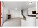 Bright and airy living room with modern fireplace, tiled floors, and staircase, seamlessly connecting spaces at 4076 Rocky Beach Dr, Las Vegas, NV 89115