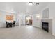 Open concept living space with dining area, fireplace, and sliding glass door leading to outdoor space at 4076 Rocky Beach Dr, Las Vegas, NV 89115