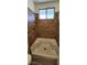 Tiled shower stall with a window, tiled walls, and wood-look tile flooring at 4308 Apex Dr, Las Vegas, NV 89147