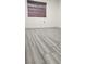 Bedroom featuring wood-look tile flooring and a window with a brown bamboo shade at 4308 Apex Dr, Las Vegas, NV 89147