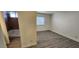 Bedroom with wood-look tile flooring, a window, and ensuite bathroom with a bathtub at 4308 Apex Dr, Las Vegas, NV 89147