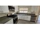 Modern kitchen with stainless steel appliances, white cabinets, and a stainless steel sink at 4308 Apex Dr, Las Vegas, NV 89147