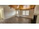 Bright living room with wood-look tile flooring, vaulted wood ceiling and a black fireplace at 4308 Apex Dr, Las Vegas, NV 89147