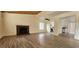 Spacious living room featuring wood-look tile floors, a brick fireplace, and an open layout at 4308 Apex Dr, Las Vegas, NV 89147