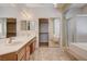 Bathroom showcases a double sink vanity, framed mirrors, and a glass enclosed shower and separate soaking tub at 4334 Libbiano Ct, Las Vegas, NV 89141
