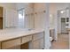 A bathroom with a single sink vanity, neutral cabinets, and a tiled floor at 4334 Libbiano Ct, Las Vegas, NV 89141