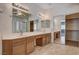 The main bathroom with double sinks, vanity, and tiled flooring looks into the walk-in closet at 4334 Libbiano Ct, Las Vegas, NV 89141