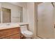 Bathroom featuring a vanity, toilet, large mirror, and a glass-enclosed shower at 4334 Libbiano Ct, Las Vegas, NV 89141