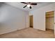 Bedroom showcasing neutral carpet, a ceiling fan, and a walk-in closet for ample storage space at 4334 Libbiano Ct, Las Vegas, NV 89141