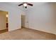 Bedroom featuring neutral carpet, ceiling fan, and doorway access to an en-suite bathroom at 4334 Libbiano Ct, Las Vegas, NV 89141