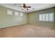 Spacious bedroom features neutral paint, plush carpet, plantation shutters, and a modern ceiling fan at 4334 Libbiano Ct, Las Vegas, NV 89141