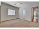 Well-lit bedroom with neutral carpet, walk-in closet, and access to an en-suite bathroom at 4334 Libbiano Ct, Las Vegas, NV 89141