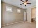 A carpeted bedroom with plantation shutters, ceiling fan, and en-suite bathroom at 4334 Libbiano Ct, Las Vegas, NV 89141