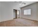 Bright bedroom featuring neutral carpet, ceiling fan, and a window for ample natural light at 4334 Libbiano Ct, Las Vegas, NV 89141