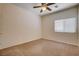 Cozy bedroom with neutral carpet, a ceiling fan, and window providing plenty of natural light at 4334 Libbiano Ct, Las Vegas, NV 89141