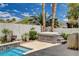 Backyard oasis with a hot tub and landscaping next to the sparkling pool and tall palm trees at 4334 Libbiano Ct, Las Vegas, NV 89141