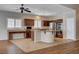 Open kitchen features granite countertops, stainless steel appliances, and a large center island with a gas cooktop at 4334 Libbiano Ct, Las Vegas, NV 89141