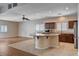 Spacious kitchen featuring a center island cooktop, stainless refrigerator, and plenty of cabinet storage at 4334 Libbiano Ct, Las Vegas, NV 89141