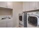 Laundry room equipped with modern appliances, a sink, and ample cabinet space for storage at 4334 Libbiano Ct, Las Vegas, NV 89141
