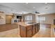 Open concept living room showcasing a kitchen island, fireplace, and modern finishes at 4334 Libbiano Ct, Las Vegas, NV 89141