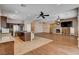 Inviting living space with a kitchen island, fireplace, wood-look flooring, and modern ceiling fans at 4334 Libbiano Ct, Las Vegas, NV 89141