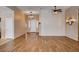 Spacious living room featuring wood floors, designer lighting, and neutral paint colors for a bright and airy feel at 4334 Libbiano Ct, Las Vegas, NV 89141