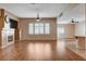 Large open-concept living room with a fireplace, shutters, and wood flooring, perfect for gatherings at 4334 Libbiano Ct, Las Vegas, NV 89141