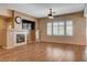 Comfortable living room featuring a fireplace, wood flooring, and plantation shutters for natural light control at 4334 Libbiano Ct, Las Vegas, NV 89141