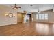 Expansive living space with wood floors, ceiling fans, recessed lighting, and views into the kitchen and dining areas at 4334 Libbiano Ct, Las Vegas, NV 89141